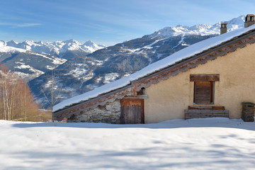 traditional alpine french cottage in mountain under the snow