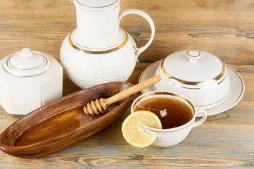 Tea with lemon and honey on the wooden background