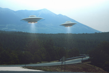 Unidentified flying object. Two UFOs flying over a road among the trees. © ktsdesign