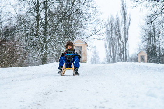 Boy riding a sled