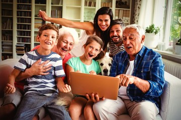 Portrait of happy multi generation using laptop