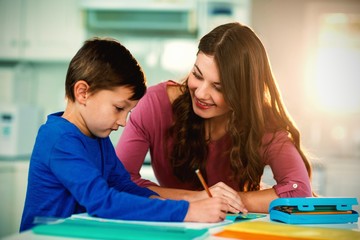 Mother helping her son doing homework