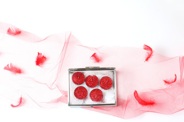 beautiful composition of a red veil and a glass box with candles in glitter. flat lay, top view, creative layout