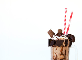 Chocolate milkshake dessert isolated on white background in mug for drink.  Sweet tooth food with copy space.