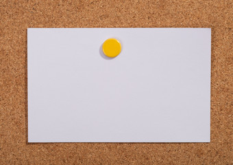 Note paper with pin on the cork board