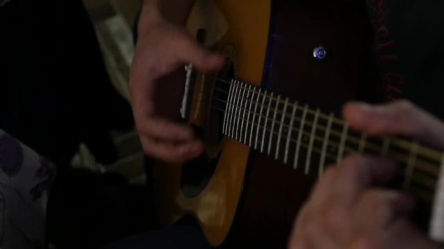 guitarist skillfully plays on a seven-stringed guitar with inspiration. slow motion