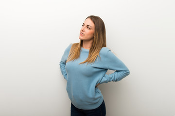 Obraz premium Blonde woman on isolated white background suffering from backache for having made an effort