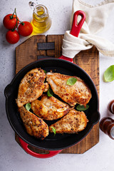 Cooked chicken breast seared in a cast iron skillet overhead