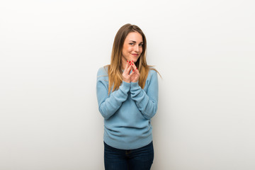 Blonde woman on isolated white background scheming something