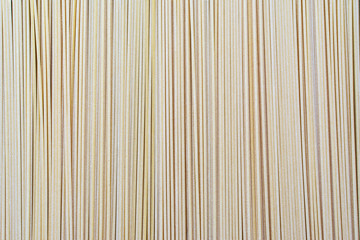 Italian spaghetti on a wooden table.Spaghetti on dark background with copy space.Figures from pasta spaghetti