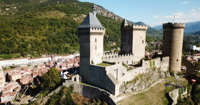 Aerial view of impressive medieval castle on rocky outcrop in French commune of Foix