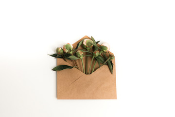 blank paper envelope with peony flowers on white background.