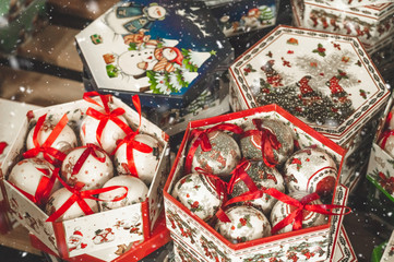 Sale of Christmas toys in the supermarket. Balls of different colors for the Christmas tree on the supermarket shelves. 