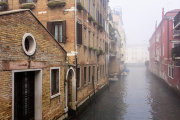 View from a bridge in the foggy canals of Venice and the Grand Canal