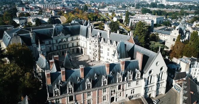 View from drone of impressive Royal Chateau de Blois on background with cityscape in sunny autumn day, France
