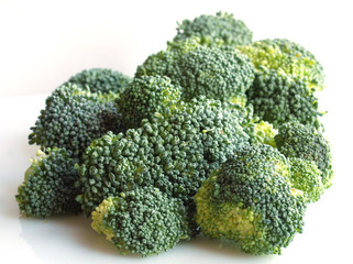 vegetables: brunch of green broccoli flowers over white background