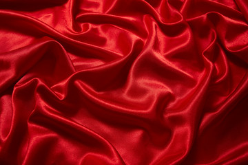 Fototapeta premium Luxury red satin smooth fabric background for celebration, ceremony, event invitation card or advertising poster