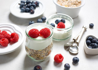 Healthy breakfast. Fresh raspberries and blueberries with yogurt and muesli.