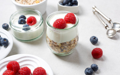 Healthy breakfast. Fresh raspberries and blueberries with yogurt and muesli.
