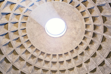 Interior dome with ray of light in Pantheon, a former Roman temple, now a church, in Rome, Italy. 