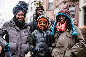 Happy family standing outdoors
