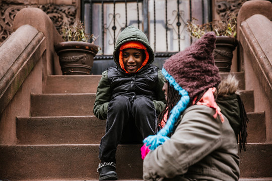 Brother and sister sitting on stairs