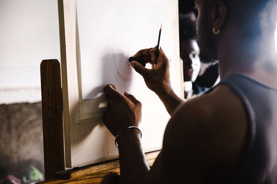 Side view of sketch artist sketching indoors