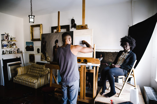 Artist sketching while standing indoors