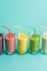 juice with diffrrent tastse on the bluew background.diet and wellbeing concept