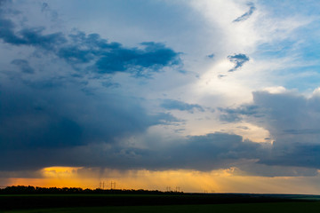 Dark clouds in sky, heavy rain starting in evening