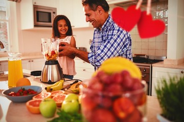 Composite image of hearts hanging on a line