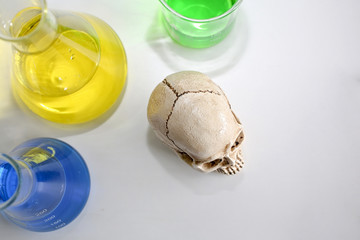 Skull and syringe. medical vials, skull and blurry syringe. Medical risk of virus abuse and death.
