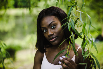 Close up of young woman holding branch in park