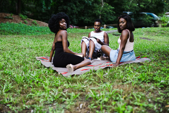 Portrait Of Friends Relaxing In Park