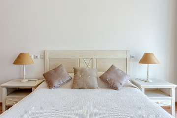 Bedroom in modern style with bed and pillows. Front view