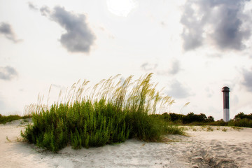 lighthouse in front of a cloudy sky on Sullivan&rsquo;s island beach South Carolina 