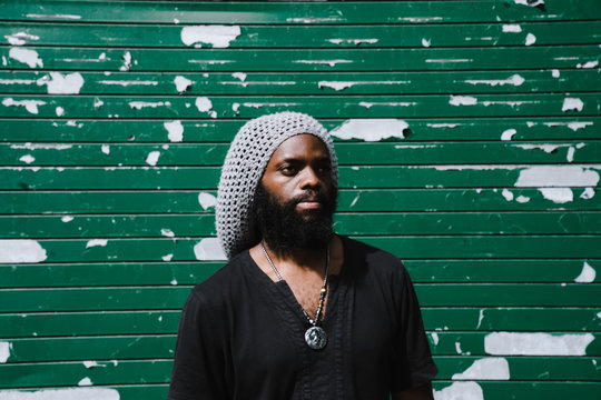 Man standing against roller shutter
