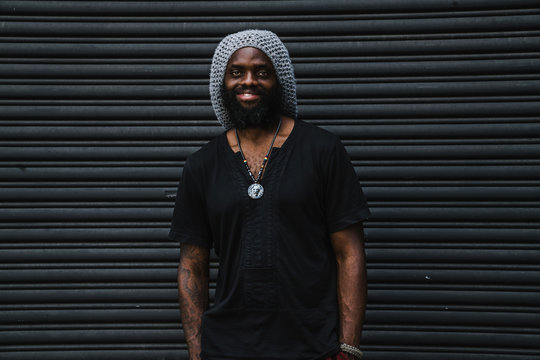 Portrait of man standing against  roller shutter