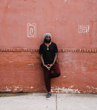 Portrait of man standing against wall