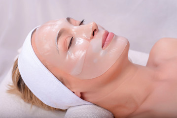 Portrait of beautiful woman with skin mask on her face