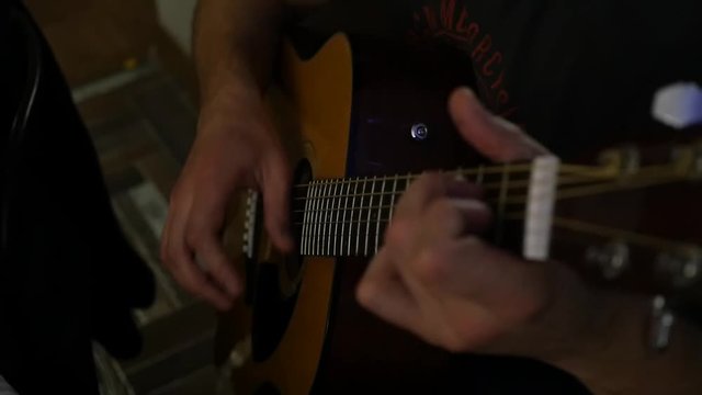 guitarist skillfully plays on a seven-stringed guitar with inspiration. slow motion