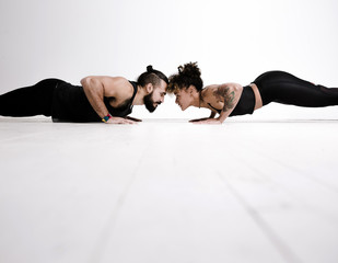 Couple exercising against white background
