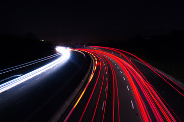 Fototapeta na wymiar Car lights in a night background, long exposition