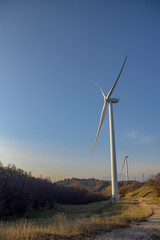 Wind turbines at sunset. Production of clean and renewable energy. Trentino, Italy