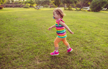 little girl spending time at backyard