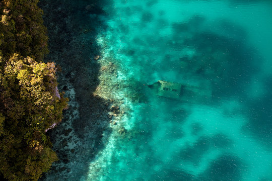 Aerial view of a shipwreck off the rock islands.