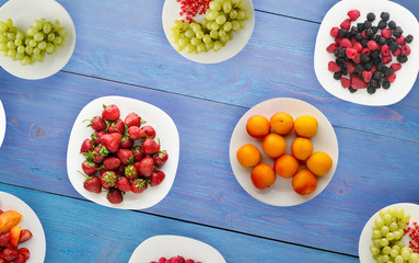fruits on a plate. vegetarian food on wooden background. vegan food top view © vitalily_73