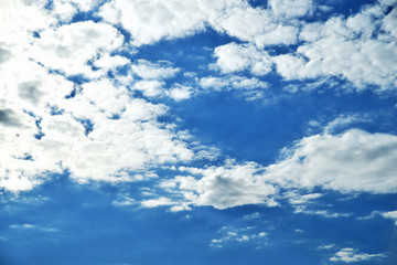 Clouds on the background of bright blue sky, summer day close-up