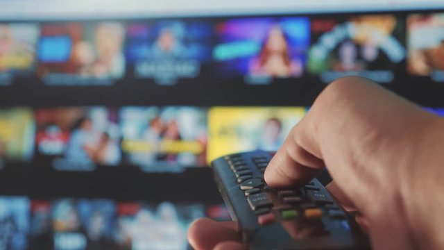 smart tv. online video lifestyle streaming service. with apps and hand. Male hand holding remote the control turn off smart tv. man hand controls holding remote. concept internet online cinema