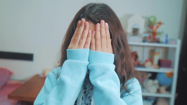 peek a boo. little girl covered her eyes face with her hands hide-and-seek waiting for a surprise lifestyle . slow motion video. teen girl playing bo-peep. childhood concept game hy - spy